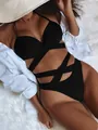 Close-up of black high-waisted bikini with criss-cross bandage straps on white fur - S / Top And Bottom / Black