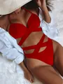 Detail shot of sexy red high-waist bikini set with cross-strap design on fur background - S / Top And Bottom / Red