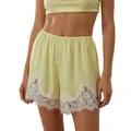 Detail of pale yellow loungewear shorts featuring elegant white lace trim and elastic waist. - S / Top And Bottom / Yellow