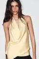 Close-up of a pale yellow satin halter top featuring a draped cross-over V-neck - S / Tops / Light Yellow