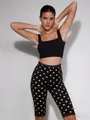 Detail view of black polka dot cropped pants with lace trim and slim fit for women - S / Bottoms / Black Polka Dot