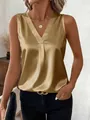 Close-up detail view of champagne gold satin sleeveless V-neck top with silky texture - S / Tops / Khaki