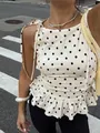 Detalle de blusa sin mangas con lunares blancos, dobladillo con volantes y lazos - S / Tops / Albaricoque