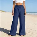 Vue complète d'un pantalon en denim bleu à jambes larges avec poches sur la plage. - S / Bas / Bleu Marine