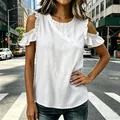 Close-up of white cold shoulder blouse with ruffled sleeves and decorative buttons. - White