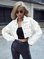 Detail view of stylish white cropped denim jacket with distressed raw hem styling - XS / Tops / White