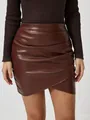 Close-up detail of a brown ruched PU leather mini skirt featuring an asymmetric wrap design - M / Bottoms / Brown