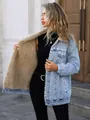 Close-up of women's oversized denim jacket showing warm beige sherpa fleece lining - XS / Tops / Light Blue