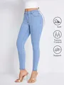 Close-up of light blue high-waist skinny jeans featuring tummy control functional icons - XL / Bottoms / Blue