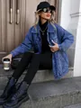Stylish oversized blue denim jacket for women, worn by a model in a casual street setting. - XS / Tops / Enzyme Washed Dark Blue