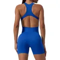 Back view of a blue seamless ribbed yoga romper with open back and racerback detail - Klein Blue