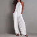 Detail of white pleated halter jumpsuit showing fabric texture and wide-leg fit - S / Top And Bottom / White