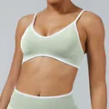 Professional mint green seamless yoga set including V-neck sports bra and high-waist leggings - XS / Tops / Pistachio Green