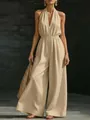 Full view of a summer beige V-neck halter jumpsuit with wide-leg design and waist tie. - S / Top And Bottom / Apricot