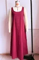 Close-up detail of a vintage red sleeveless bohemian maxi dress displayed on a mannequin - Red