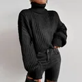 Detailed view of women's oversized black turtleneck knit sweater with drop shoulders - S / Tops / Black