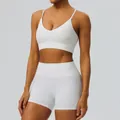 White two-piece yoga set featuring a V-neck sports bra and high-waisted fitness shorts. - S / Top And Bottom / White