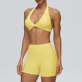 Women's two-piece pale yellow yoga set featuring a halter sports bra and high-waisted shorts - S / Top And Bottom / Pudding Yellow