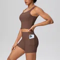 Detail view of high-waisted yoga shorts with a side pocket holding a smartphone - S / Top And Bottom / Chestnut Brown