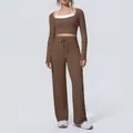 Model wearing a three-piece brown yoga set with long-sleeve top and wide-leg pants - S / Top And Bottom / Chestnut Brown