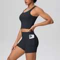 Close-up detail of black athletic yoga set featuring side pocket shorts and sports bra - S / Top And Bottom / Black