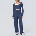 Detail view of women's blue color-block yoga set with long sleeve top and wide-leg pants - S / Top And Bottom / Navy Blue