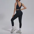 Detail view of black yoga set featuring V-neck sports bra and high-waisted leggings - S / Top And Bottom / Black