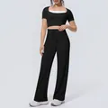 Close-up of a stylish black sports yoga set featuring wide-leg pants and a halter neck top. - S / Top And Bottom / Black