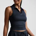 Detail view of a navy blue sleeveless polo collar sports top with a matching yoga tennis skirt - S / Tops / Black