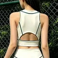 Vista trasera de un top de tenis blanco con ribete verde y detalle de espalda abierta - S / Tops / Albaricoque Beige