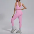 Rear view of model wearing pink V-neck sports bra and high-waisted yoga leggings set - Sakura Pink