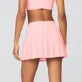 Back view of a premium pink pleated tennis skirt variant for sports and fitness - S / Bottoms / Pink