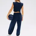 Women's navy blue two-piece sportswear set featuring sleeveless crop top and pocket joggers - S / Bottoms / Sapphire Blue