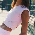 Women's pink two-piece athletic set featuring a sleeveless crop top and matching shorts - L / Tops / Pink
