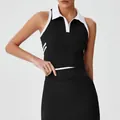 Slank fitte mouwloze polo sportvest en tennisrok set in klassiek zwart en wit kleuren - M / Tops / Zwart