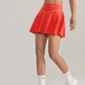 High-waist red tennis skirt with white V-shaped piping detail for athletic fitness - S / Bottoms / Orange