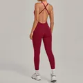 Achteraanzicht van een bordeauxrode yoga jumpsuit met kruisbandjes en open rug. - S / Boven- En Onderstuk / Robijnrood