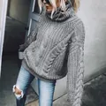 Close-up of a women's grey chunky knit turtleneck sweater with cable patterns. - S / Tops / Gray