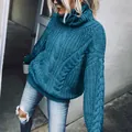 Detailed view showing the thick cable-knit texture of this cozy blue turtleneck sweater. - S / Tops / Blue