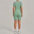 Back view of a green short-sleeve yoga bodysuit with stand collar and athletic fit - Bean Green