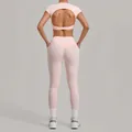 Pink yoga set for women featuring an open back short sleeve top and pocketed leggings - S / Top And Bottom / Ballet Powder