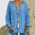 Detail of women's blue cable knit hooded sweater with a stylish V-neck design. - Denim Blue