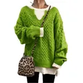 Close-up showing textured cable knit of the vibrant green sweater and layering. - S / Tops / Green