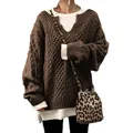 Detailed view of women's oversized brown cable-knit sweater with white layering. - S / Tops / Khaki
