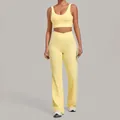 Two-piece yellow yoga set featuring a sports bra and high-waisted flared workout leggings - Durian Yellow