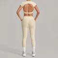 Beige two-piece yoga set featuring open back crop top and high-waist leggings - Cream Apricot