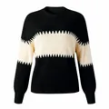 Detailed view of a women's black and cream color-blocked knit sweater with lantern sleeves - Black