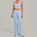 Light blue two-piece yoga set including a sports bra and flared crossover pants. - Sky Blue