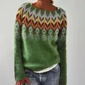 Detailed close-up of the intricate colorful jacquard pattern on this green knit sweater. - Feather