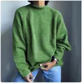 Macro view of a women's green oversized knit sweater with casual loose fit style - S / Tops / Green